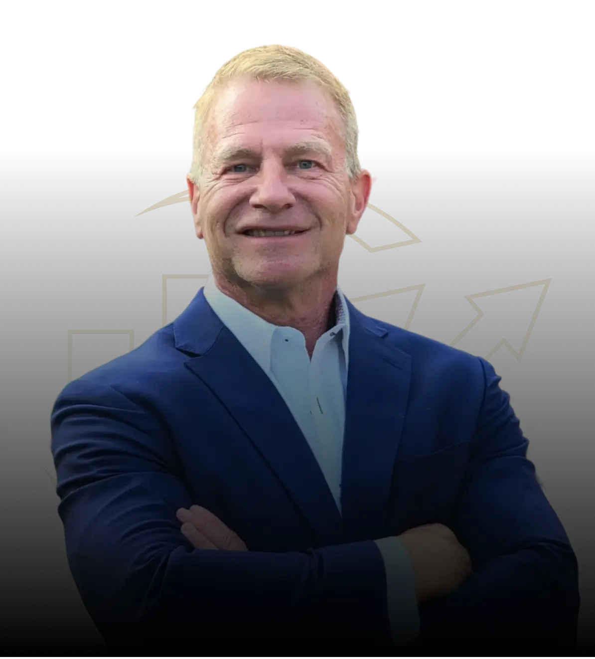 Jerry smiling in a blue suit with his arms crossed.